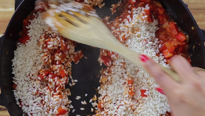 Agregar el arroz y tostar durante 3-4 minutos a fuego medio sin enjuagarlo. Desglasar la sartén con vino blanco seco (opcional).