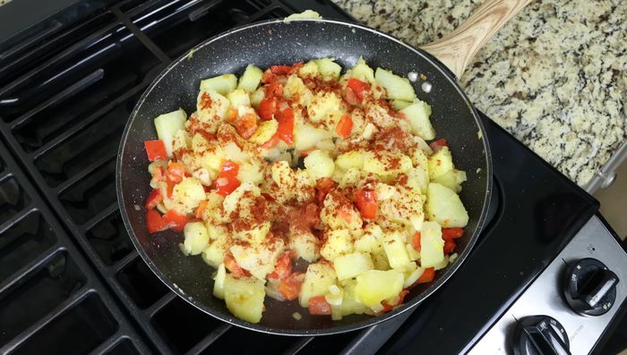 Incorporar el pimentón dulce ahumado, mezclar rápidamente y añadir los huevos batidos. Cocinar a fuego medio-bajo durante 2-3 minutos, mezclando suavemente hasta que los huevos estén cuajados.