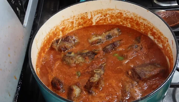Agregar las costillas de puerco a la olla con la salsa. Tapar y dejar cocer a fuego lento durante aproximadamente media hora, removiendo ocasionalmente.