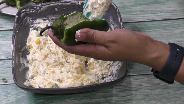 Fill jalapeño peppers with the cheese mixture.