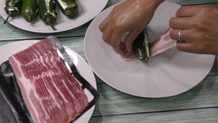 Wrap each jalapeño pepper with bacon slices (use two slices for larger peppers).