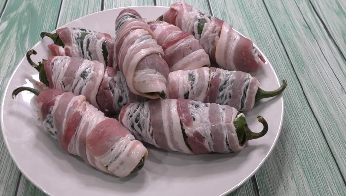 Cook jalapeños in a hot pan, grill, or oven until bacon is crispy and jalapeños are browned. (Note: Bacon releases fat, so adding oil may not be necessary.)
