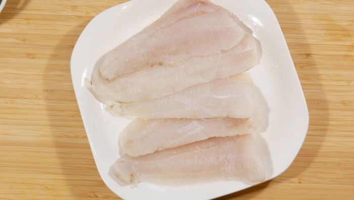 Salpimentar los filetes de merluza.