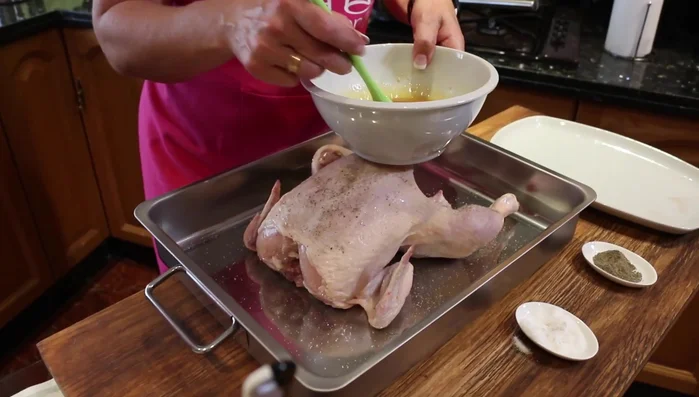 Untamos el pollo: Untamos el pollo con la marinada, asegurándonos de cubrir toda la superficie. Dejamos reposar durante 10-15 minutos para que el pollo se marine y no se seque durante la cocción. (153.04)